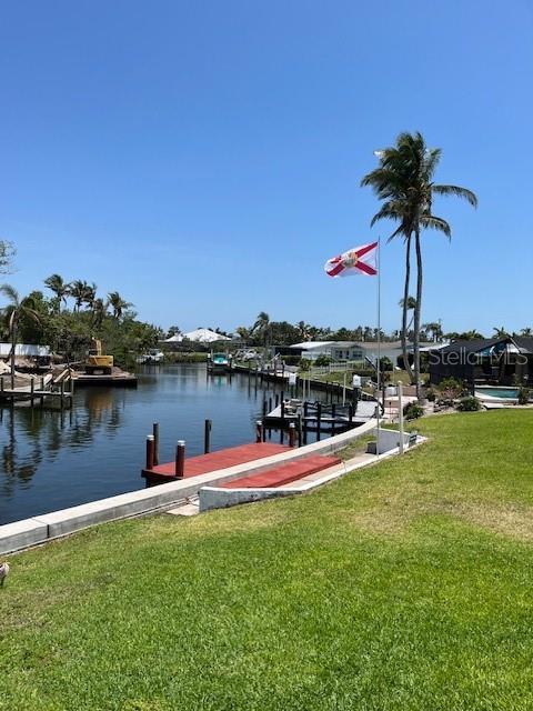 5111 Coral Blvd, Bradenton, FL 34210 - dock featuring a lawn and a water view