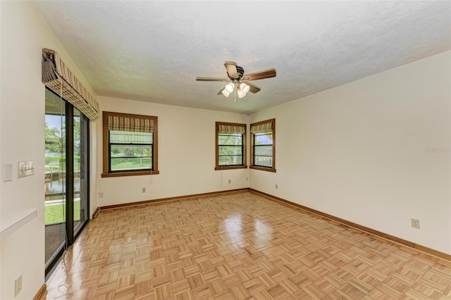 5111 Coral Blvd, Bradenton, FL 34210 - empty room featuring a ceiling fan, healthy amount of natural light, a textured ceiling, and baseboards