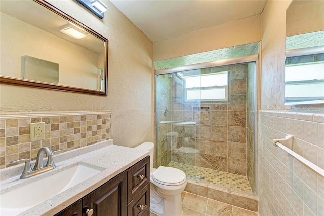 5111 Coral Blvd, Bradenton, FL 34210 - full bath featuring a shower stall, toilet, a textured wall, vanity, and tasteful backsplash