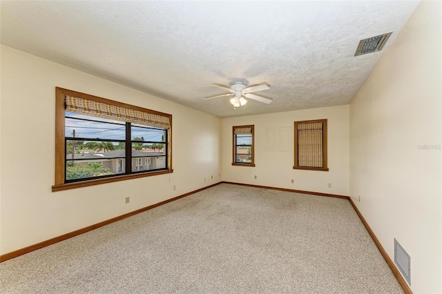 5111 Coral Blvd, Bradenton, FL 34210 - unfurnished room with light carpet, a ceiling fan, baseboards, and a textured ceiling