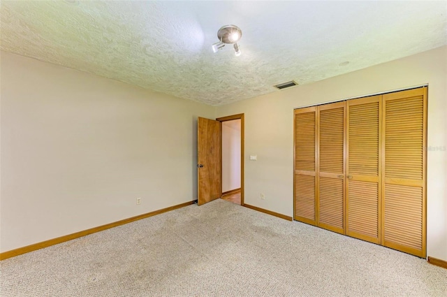 5111 Coral Blvd, Bradenton, FL 34210 - unfurnished bedroom with carpet flooring, baseboards, a textured ceiling, and a closet
