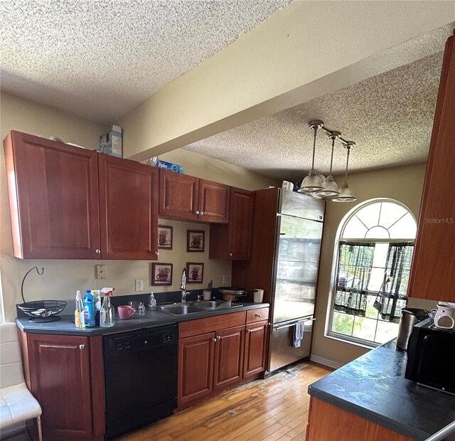 kitchen with stainless steel built in refrigerator, sink, light hardwood / wood-style flooring, black dishwasher, and hanging light fixtures