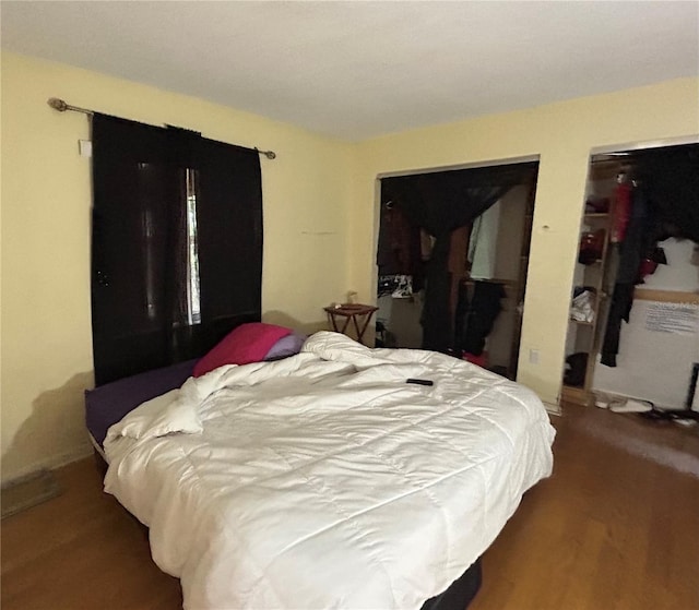 bedroom with dark wood-style floors