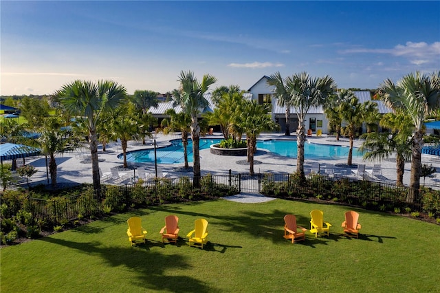 view of swimming pool with a yard