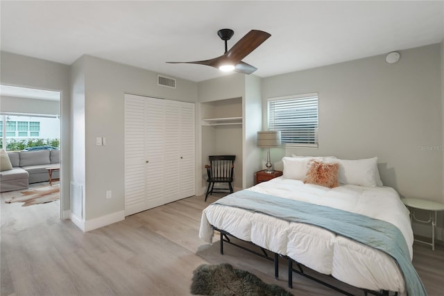 bedroom with ceiling fan and light hardwood / wood-style flooring