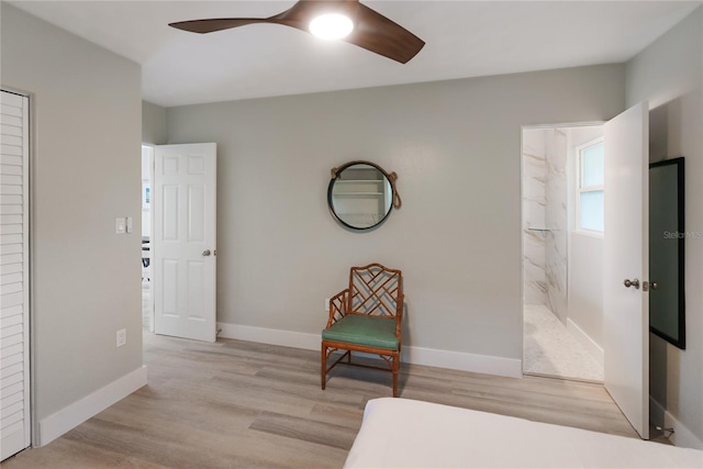 bedroom with ceiling fan, light hardwood / wood-style floors, and ensuite bath