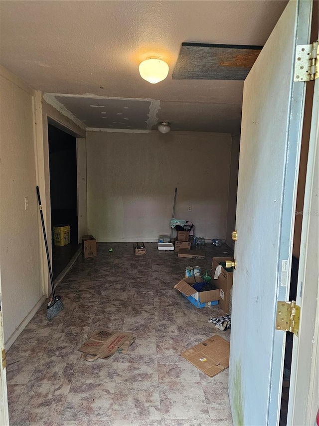 hallway with tile patterned flooring and a textured ceiling