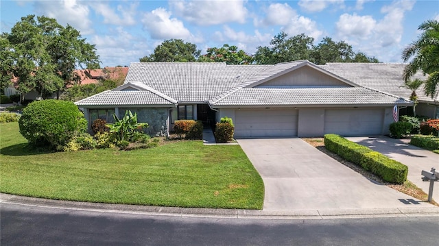 single story home with a garage and a front yard