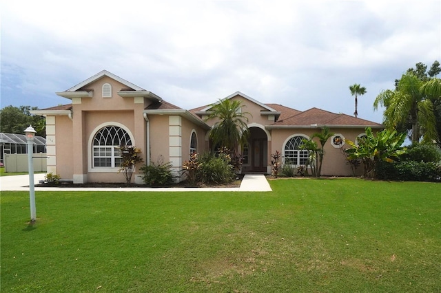 mediterranean / spanish house with a front yard