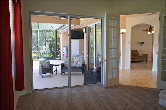 doorway to outside with ceiling fan, light colored carpet, and french doors