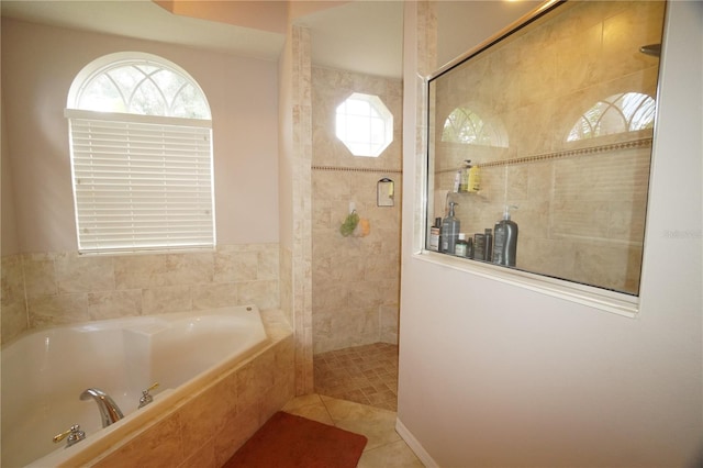 bathroom featuring tile patterned flooring and separate shower and tub