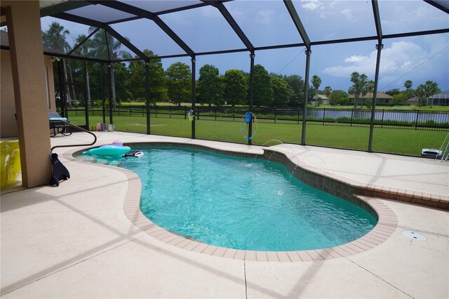 view of pool with a patio area, a yard, and a lanai