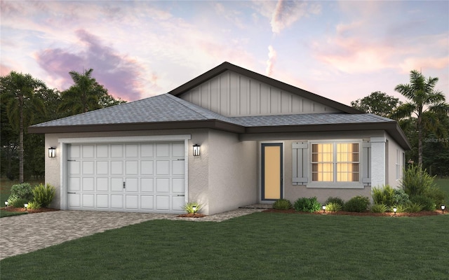 view of front facade with a garage and a lawn