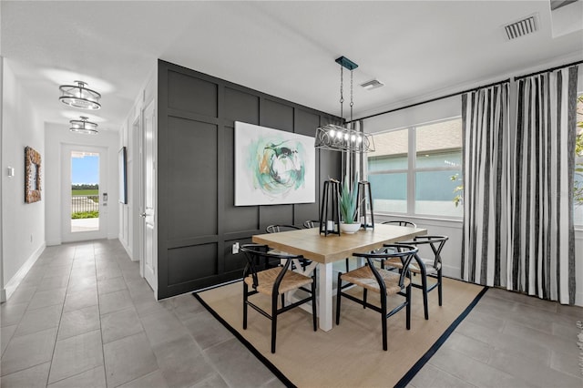 dining area featuring a chandelier and light tile patterned floors