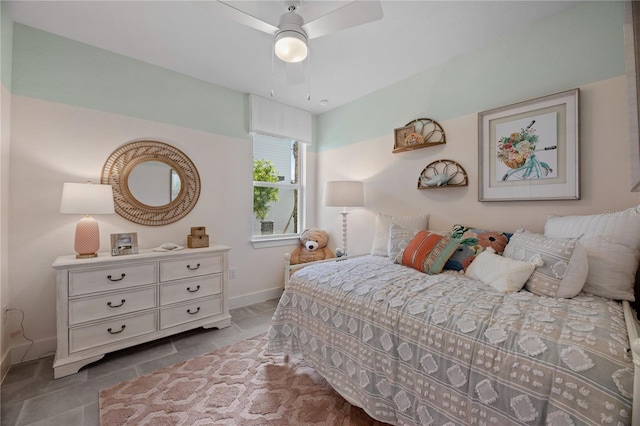 tiled bedroom featuring ceiling fan