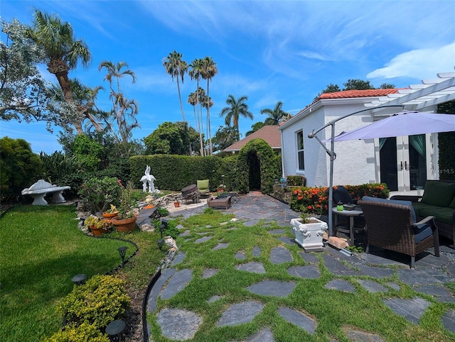 view of yard featuring a patio area, outdoor lounge area, and french doors