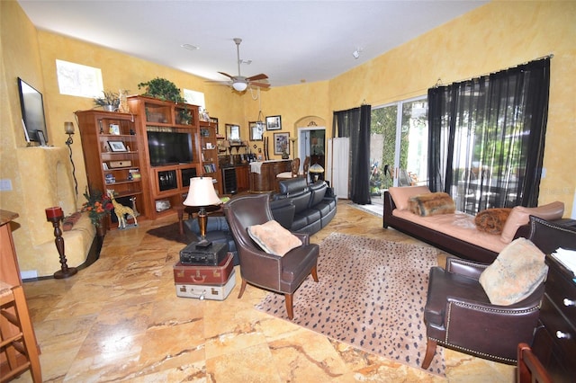 tiled living room featuring ceiling fan