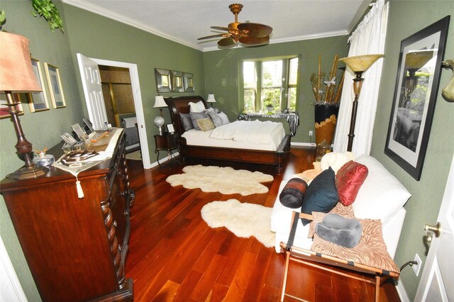 bedroom with ceiling fan, hardwood / wood-style flooring, and crown molding