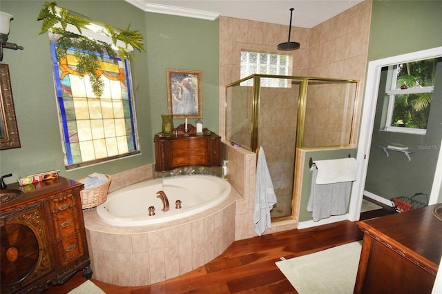 bathroom with ornamental molding, vanity, separate shower and tub, and hardwood / wood-style flooring