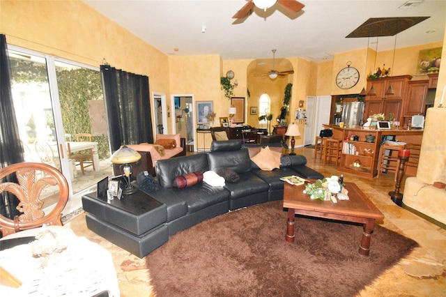 tiled living room with ceiling fan