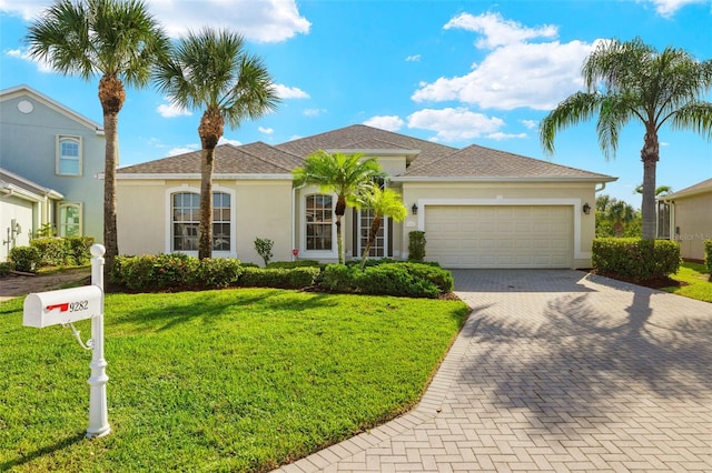 view of front of property with a front lawn and a garage