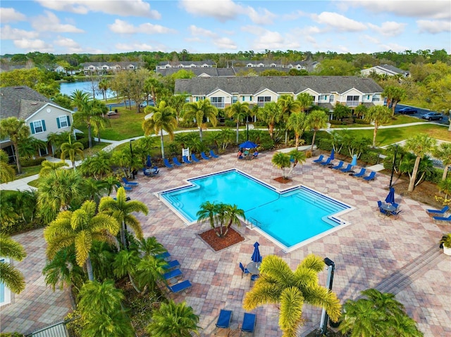 pool featuring a patio area, a residential view, and fence