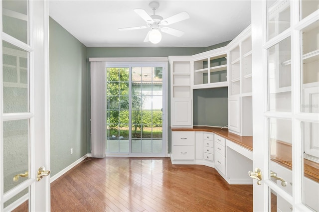 unfurnished office featuring ceiling fan and wood-type flooring