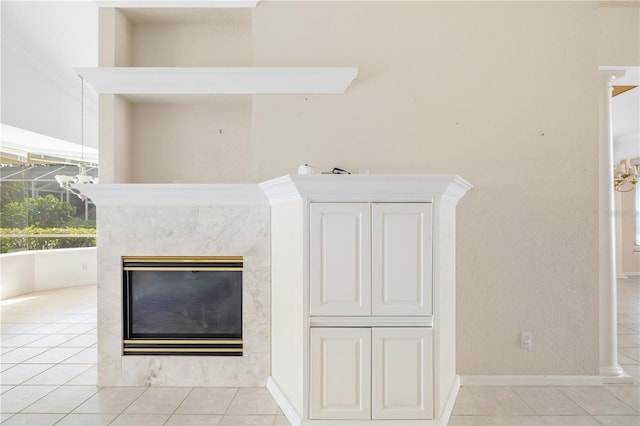 interior space featuring light tile patterned floors and a high end fireplace