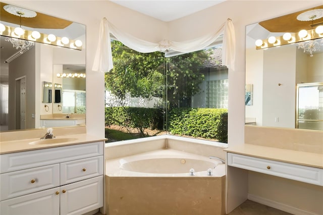 bathroom with a washtub and vanity