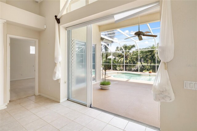 doorway to outside featuring ceiling fan and light tile patterned floors