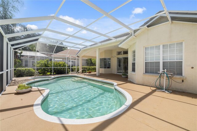 view of swimming pool with a patio area and a lanai