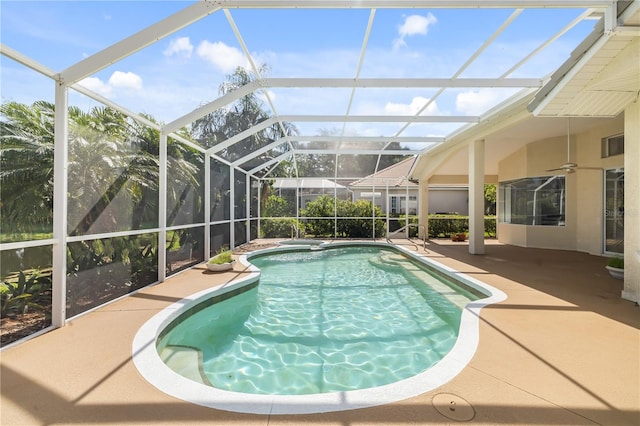 view of pool featuring a patio area, ceiling fan, and glass enclosure