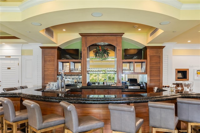 bar with crown molding and a tray ceiling