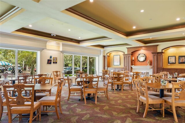 dining room featuring crown molding, dark carpet, a wealth of natural light, and coffered ceiling