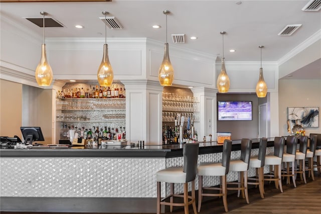 bar featuring ornamental molding, pendant lighting, white cabinets, and dark wood-type flooring