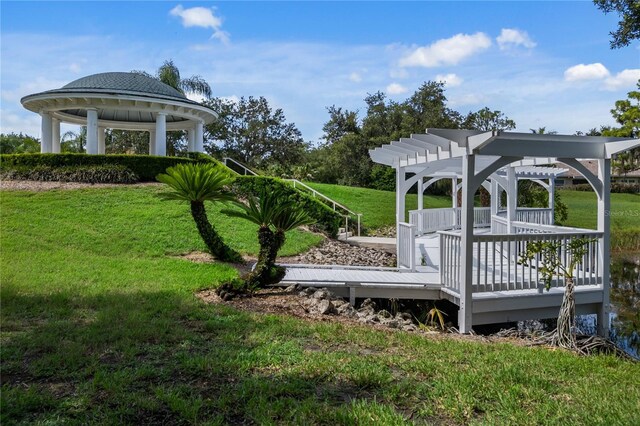 view of yard featuring a pergola, a wooden deck, and a gazebo