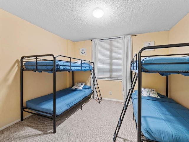 bedroom featuring a textured ceiling and carpet flooring