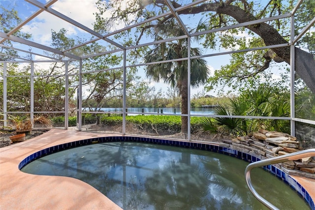 view of pool with a lanai and a water view