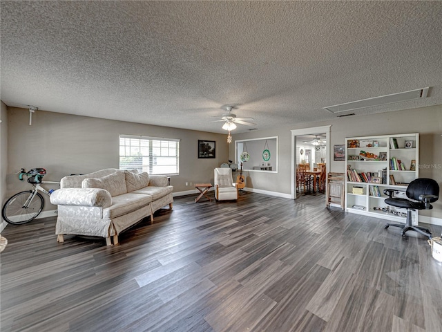 living room featuring a textured ceiling, ceiling fan, and hardwood / wood-style flooring