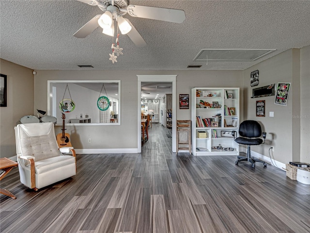 interior space with ceiling fan, wood-type flooring, and a textured ceiling