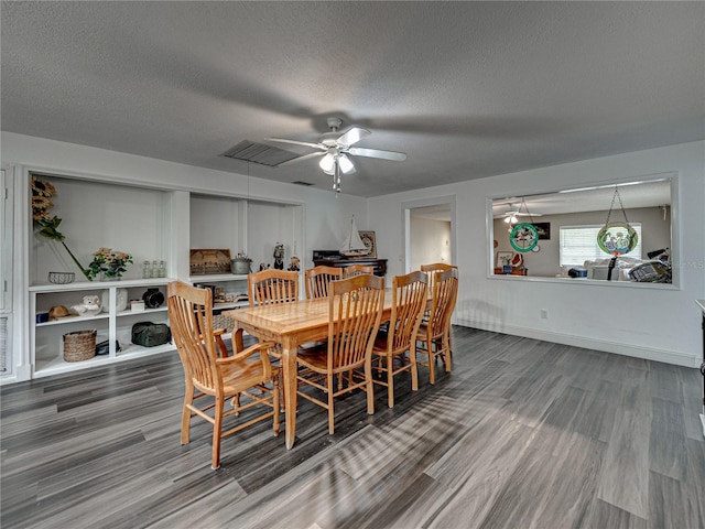 dining room with a textured ceiling, ceiling fan, and hardwood / wood-style floors