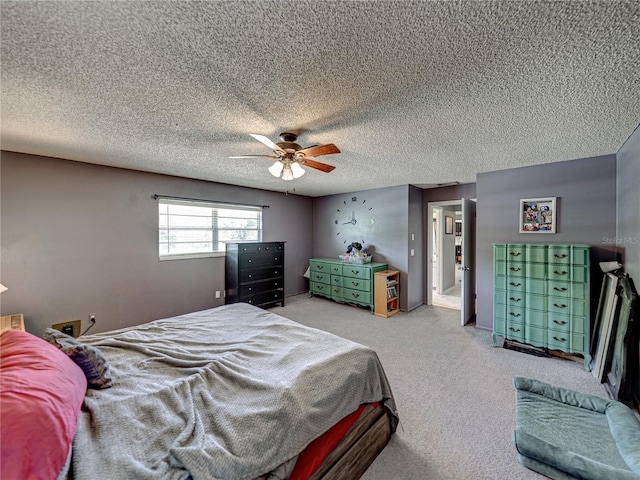 bedroom with light carpet, ceiling fan, and a textured ceiling