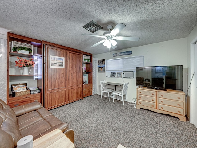 carpeted living room with ceiling fan and a textured ceiling