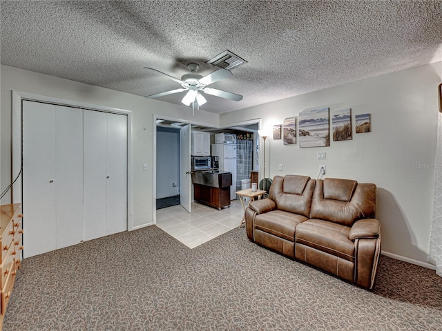 carpeted living room featuring a textured ceiling and ceiling fan