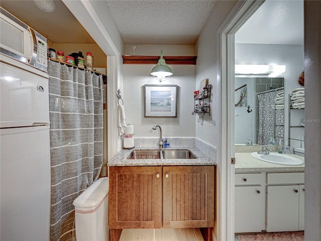 bathroom featuring vanity and a textured ceiling