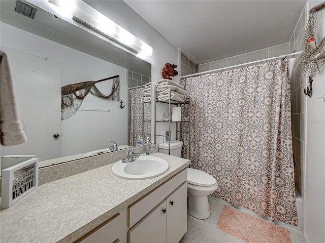 bathroom with vanity, tile patterned flooring, and toilet