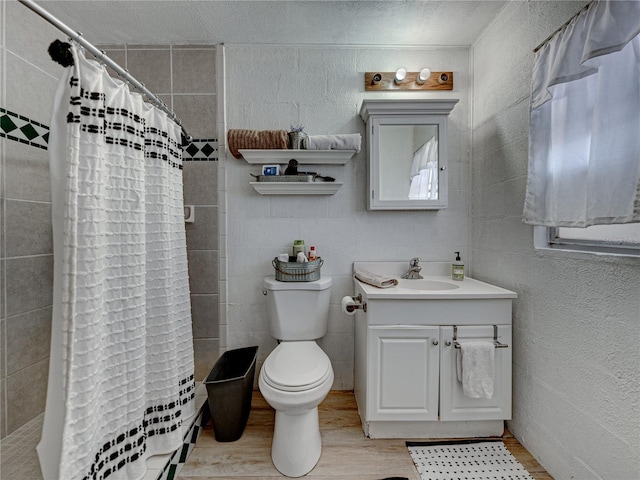 bathroom with hardwood / wood-style flooring, toilet, and vanity