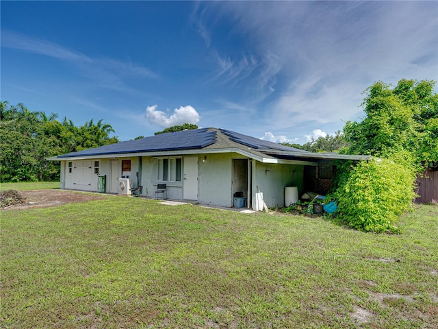 back of property with a lawn