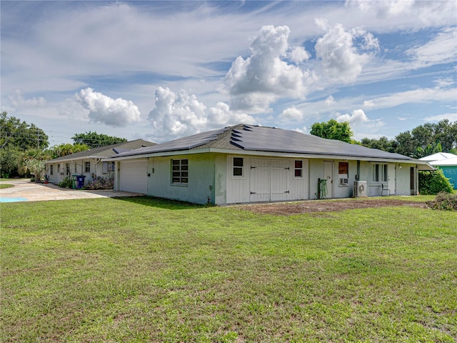 exterior space featuring a garage and a front lawn