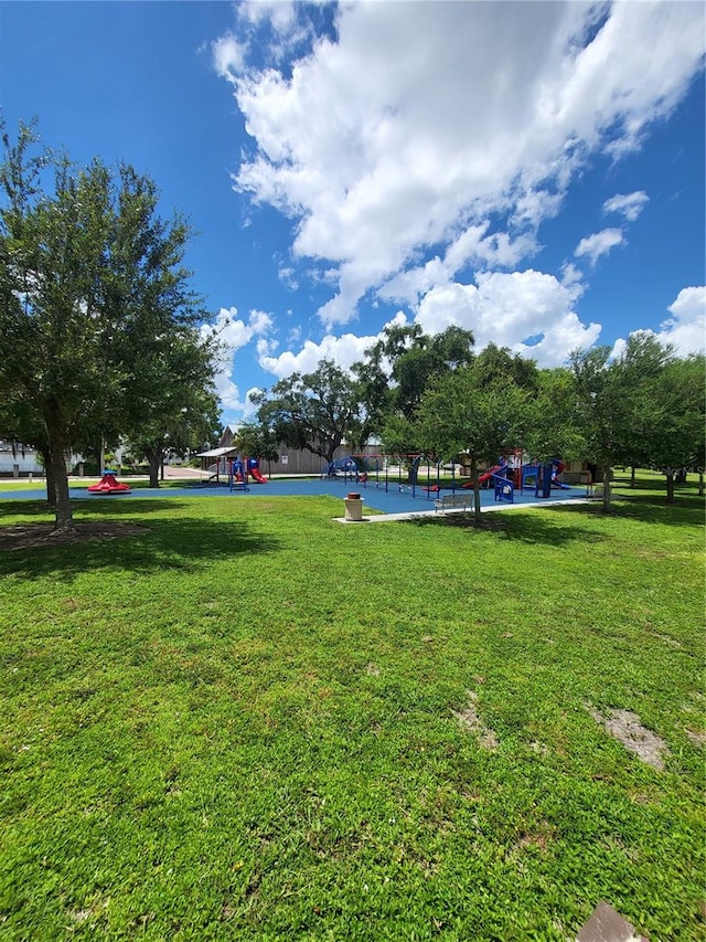 surrounding community featuring a playground and a lawn